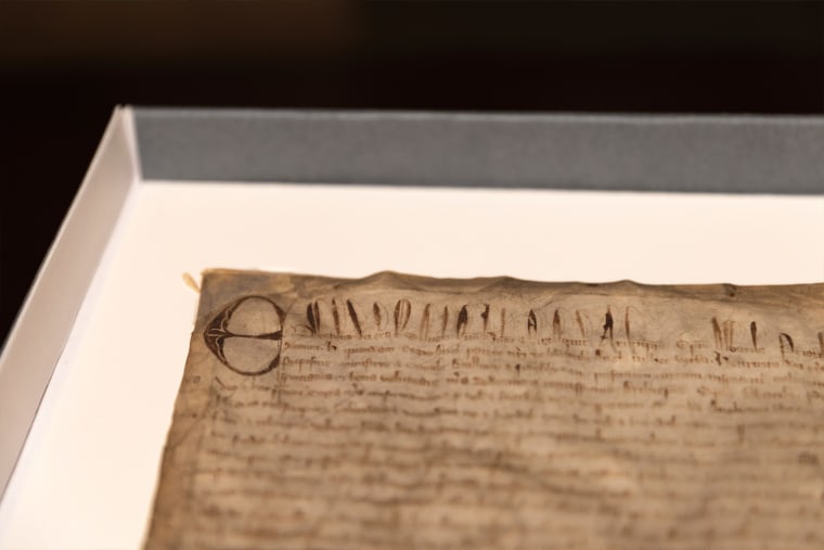 This photo shows a rare copy of the Magna Carta from 1300 sitting in a display case on April 15, 2025, at Harvard Law School in Cambridge, Mass.