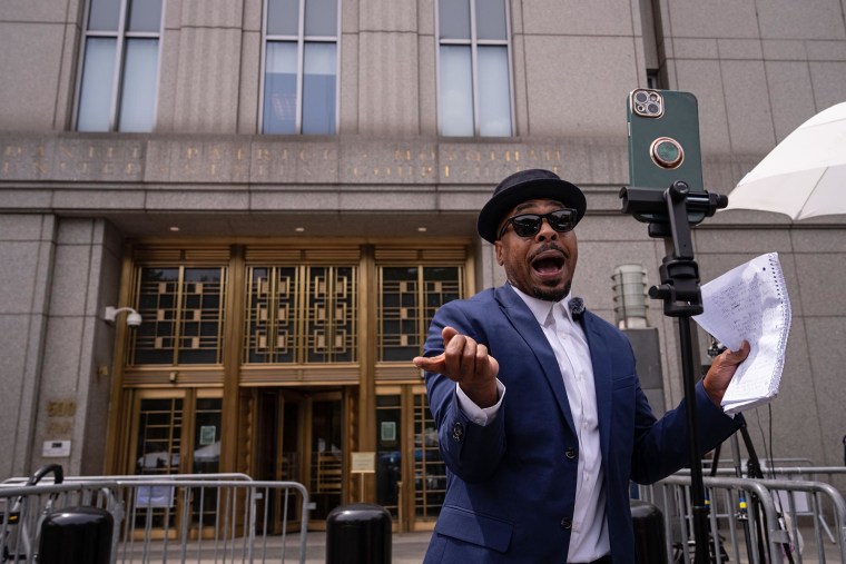 A person records for social media with their phone outside of the trial of Sean "Diddy" Combs on May 27, 2025 in New York.