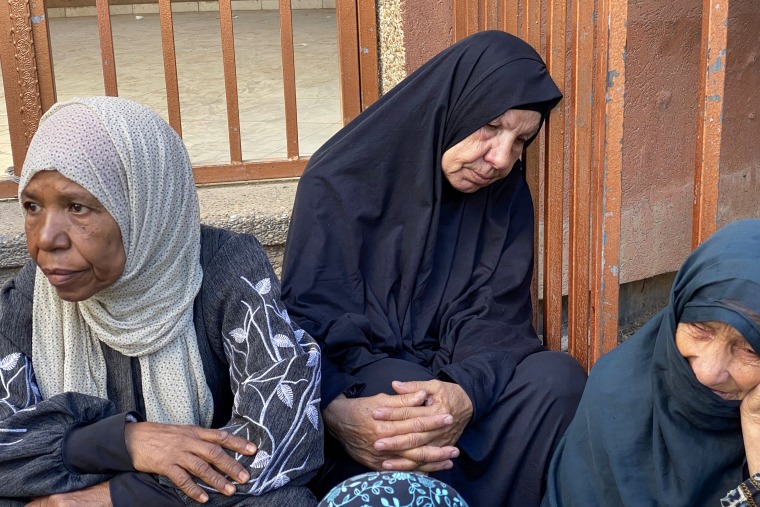 Palestinians mourn relatives.