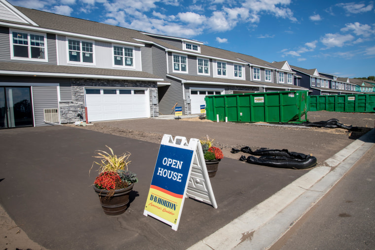 Newly built townhome with open house sign