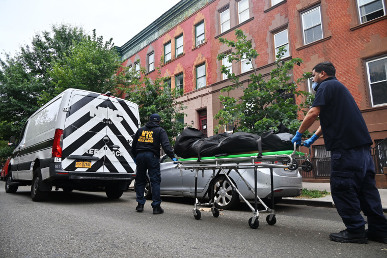 Members of the New York City Office of Chief Medical Examiner remove the body of Influencer model Donald Zieben-Hood in Harlem, New York, on Aug. 1.